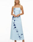 Model in elegant A-line Carmen Dress adorned with sweeping botanical embroidery, designed for summer celebrations and unforgettable occasions.