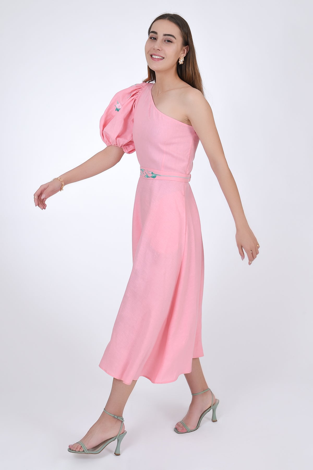 Fanm Mon Ayisha Midi Linen one shoulder Dress, side view with movement. Featuring a puff sleeve one shoulder design with embroidered floral pattern.