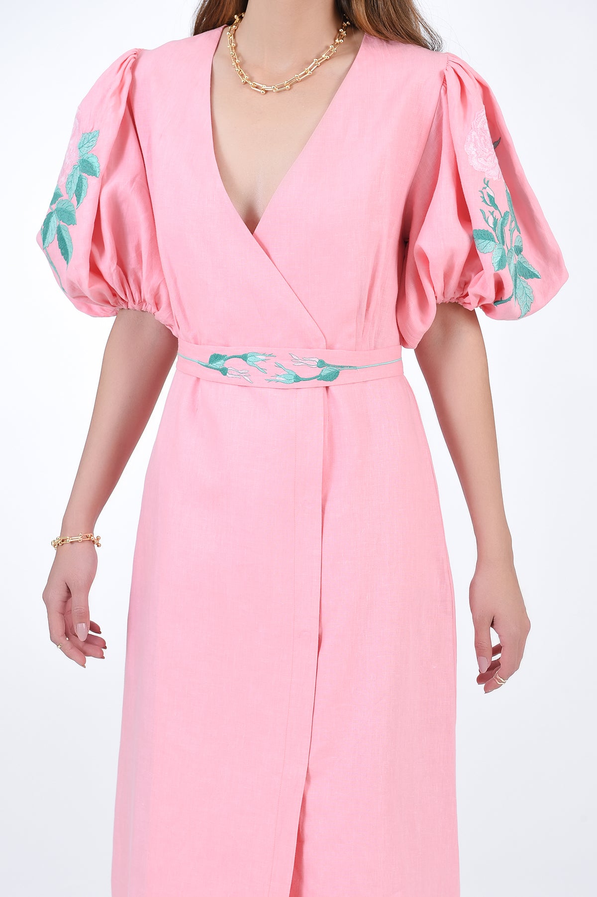 Luti Front detail view showcasing embroidery detail on sleeves and detectable belt.