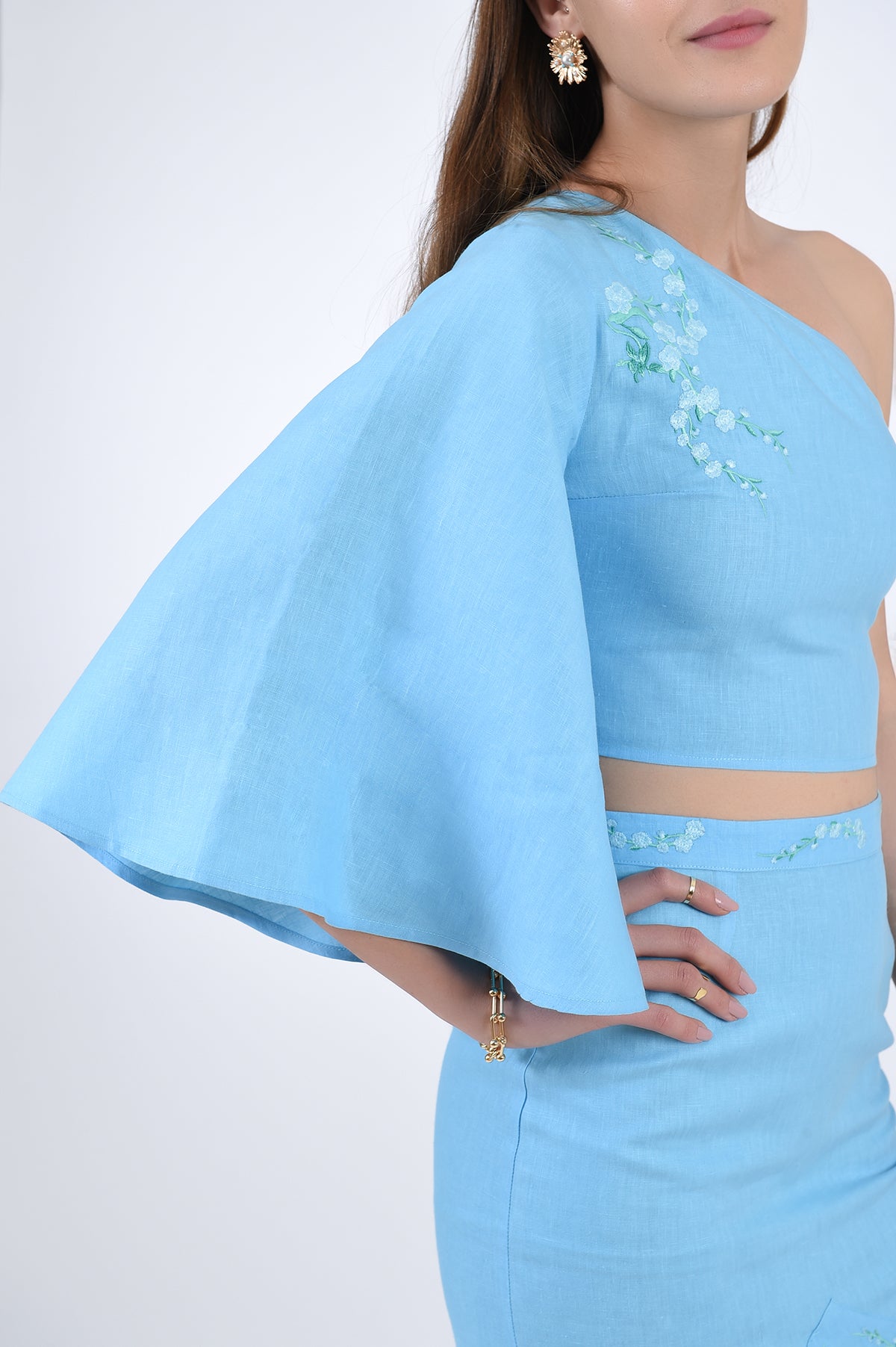 Merve showcasing embroidery details and bell sleeve.