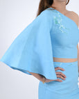 Merve showcasing embroidery details and bell sleeve.