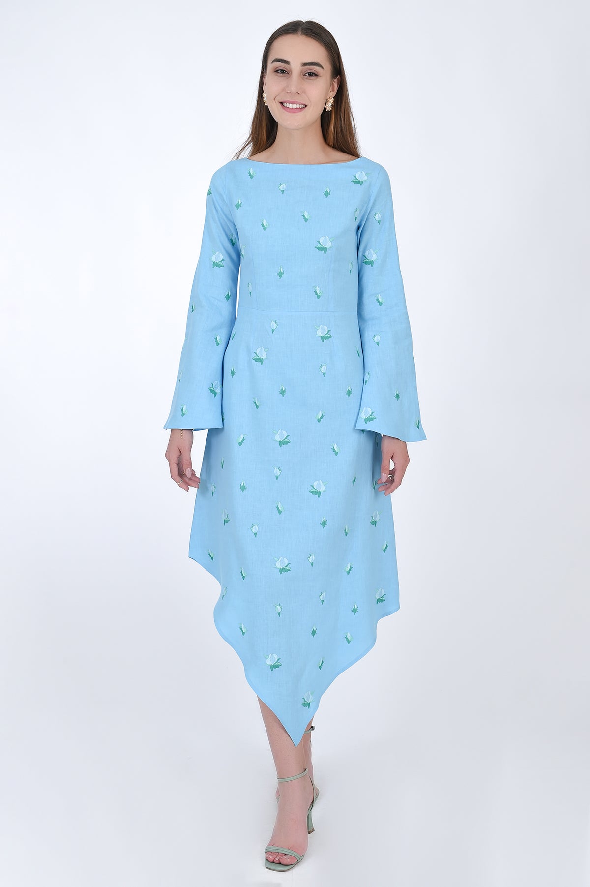 Fanm Mon Choupet Asymmetrical Linen dress, front view.  Features long bell sleeves,  a boat neckline and hits mid length. Detailed with intricate floral-inspired embroidery a Fanm Mon signature. 