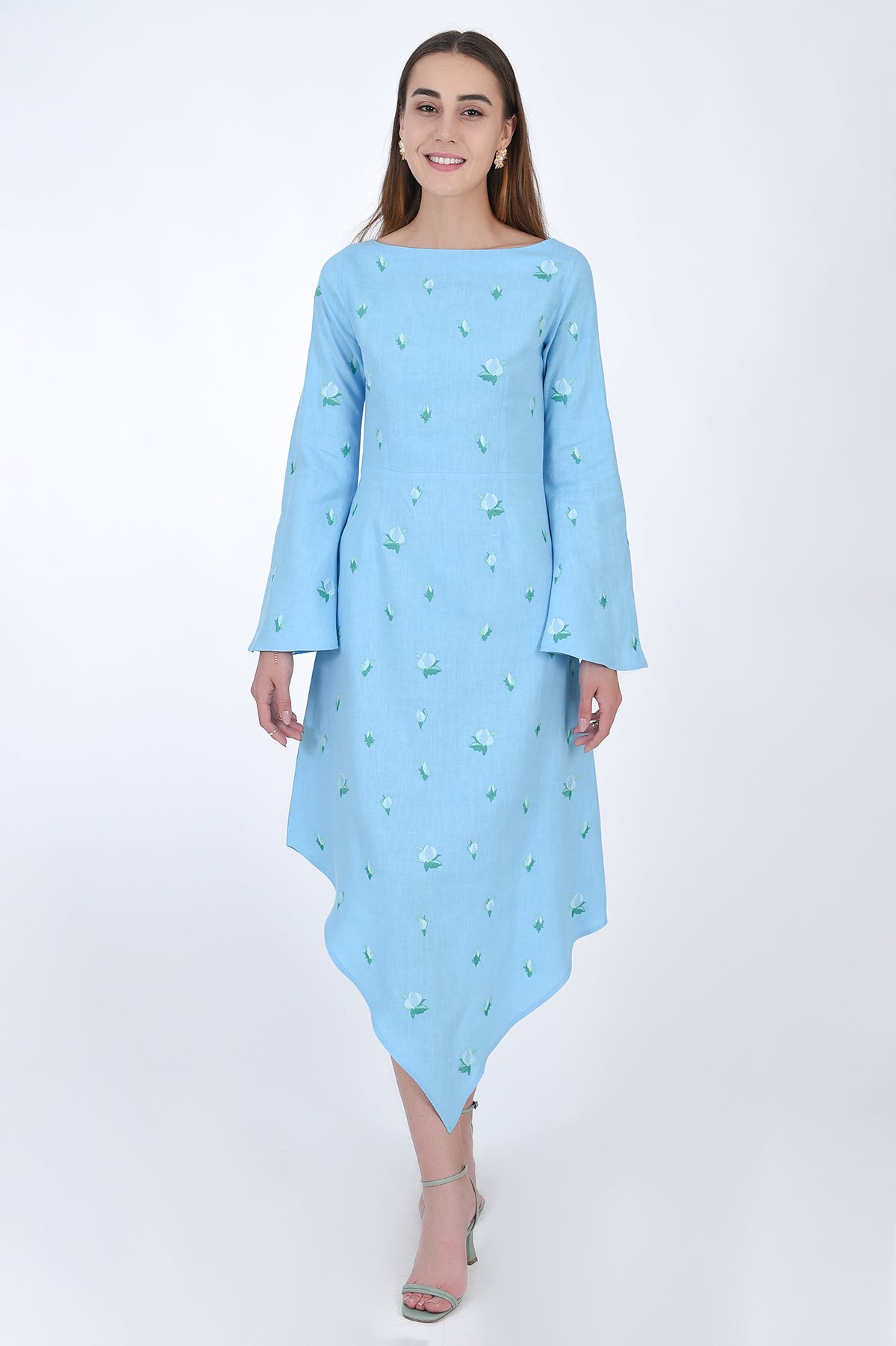 Fanm Mon Choupet Asymmetrical Linen dress, front view.  Features long bell sleeves,  a boat neckline and hits mid length. Detailed with intricate floral-inspired embroidery a Fanm Mon signature.
