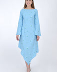 Fanm Mon Choupet Asymmetrical Linen dress, front view. Features long bell sleeves, a boat neckline and hits mid length. Detailed with intricate floral-inspired embroidery a Fanm Mon signature.