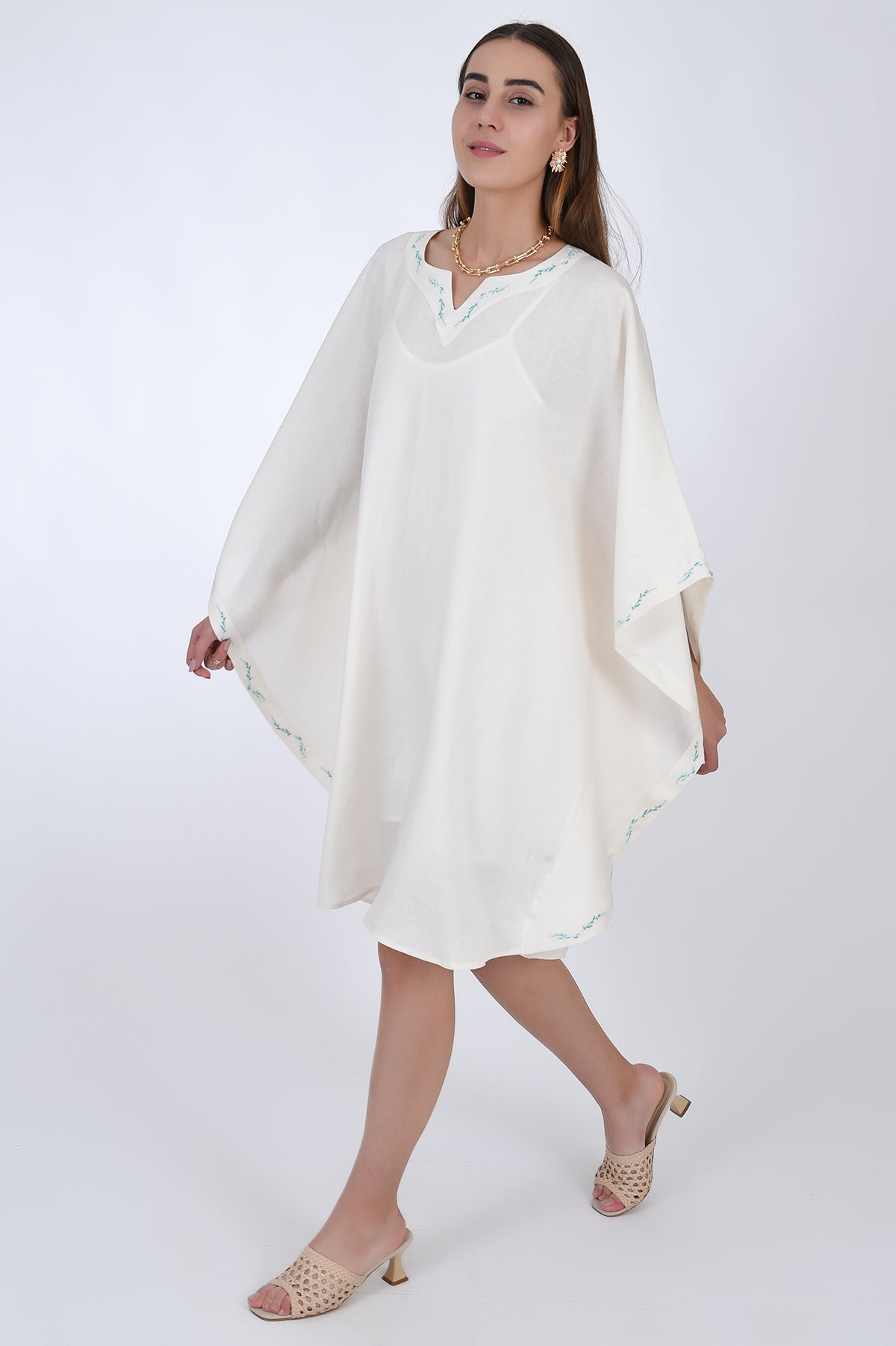 Fanm Mon Lage Linen Kaftan Dress in Ivory, side view with movement, showcasing the sleeves. 