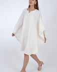 Fanm Mon Lage Linen Kaftan Dress in Ivory, side view with movement, showcasing the sleeves. 