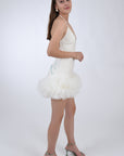 Fanm Mon Electra Linen mini dress, side view. Features a halter neckline, spaghetti straps, open back, and tulle hemline. The dress is also detailed with embroidery.