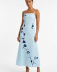 Fanm Mon Carmen Dress featuring oversized floral vine embroidery, adjustable spaghetti straps, and an elegant A-line maxi silhouette.