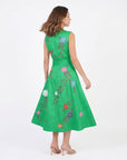 Model wearing the Fanm Mon Jules Dress featuring hand-placed floral vine embroidery, sleeveless bodice, self-tie waist belt, and flowing midi skirt in back view against a neutral background.