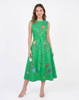 Model wearing the Fanm Mon Jules Dress with floral vine embroidery, sleeveless round neckline, self-tie waist belt, and elegant midi silhouette in front view against a neutral background.