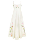 Fanm Mon Leyla Dress featuring hand-embroidered tulips, cosmos, buttercups, and lilies on a flowing empire waist maxi silhouette with a square neckline.