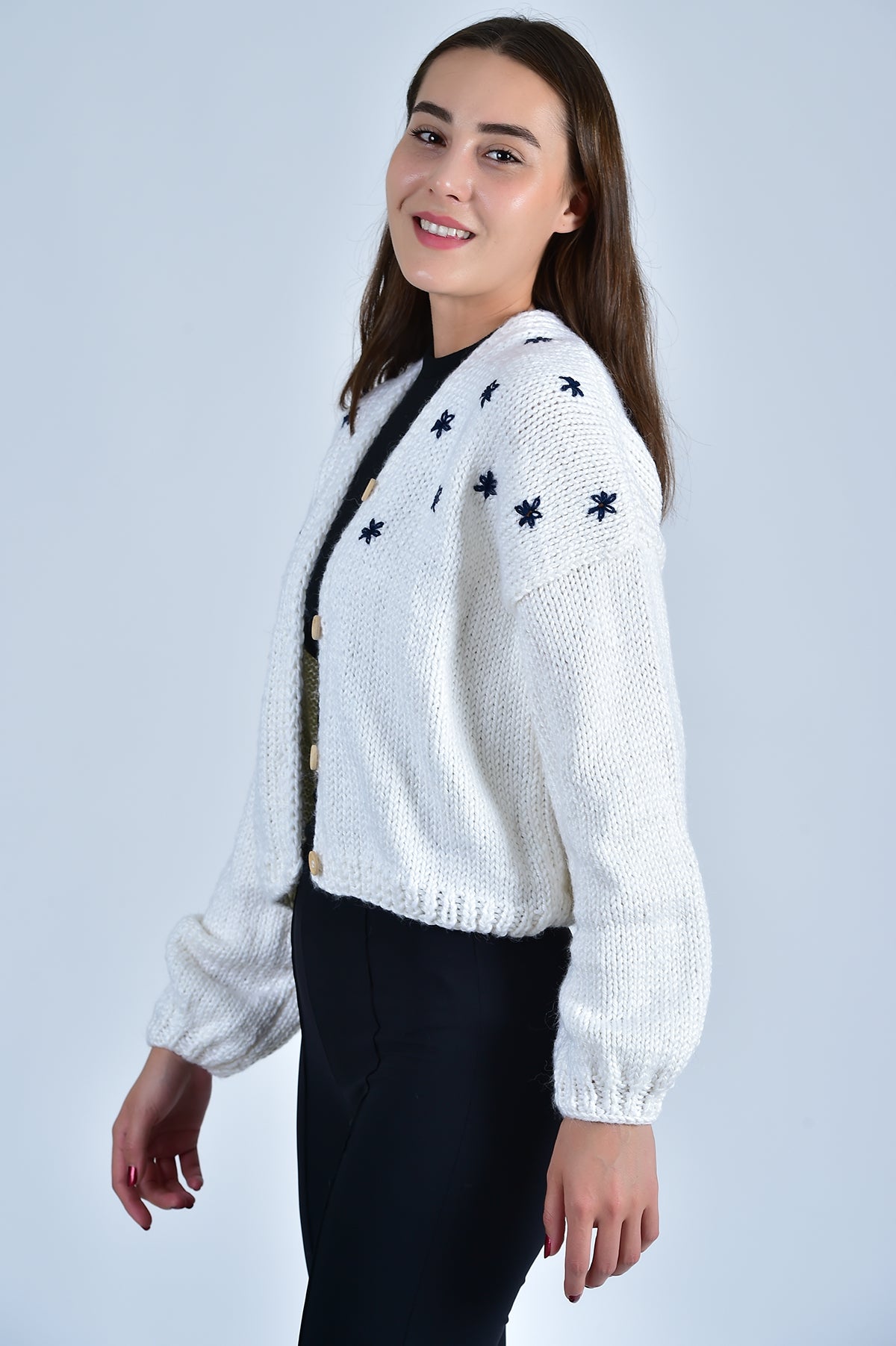 Side View of the Cropped Sister Bloom Cardigan in White with Navy Floral Embroidery