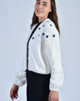 Side View of the Cropped Sister Bloom Cardigan in White with Navy Floral Embroidery