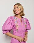Fanm Mon Santiago deep plum dress with floral embroidery details and front slit with puff sleeves .
