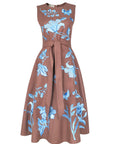 Fanm Mon Gera Dress featuring blue floral, butterfly, and dragonfly embroidery with a sleeveless bodice, self-tie waist, and full midi skirt.