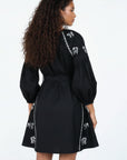 Back view of the Fanm Mon Handan Dress featuring three-quarter balloon sleeves, a self-tie waist, and equestrian-inspired embroidery along the shoulders and skirt.