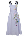 Famn Mon Mimoza Lilac dress with floral embroidery and black bow straps on a white background