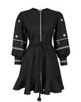 Fanm Mon Noen Dress in black with white daisy embroidery, long blouson sleeves, braided tie waist and ruffled mini hem