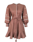 Fanm Mon Noen Dress featuring floral embroidered sleeves, white embroidered trim, braided tie waist and ruffled mini skirt