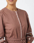 Fanm Mon Noen Dress detail featuring white daisy and golden floral embroidery, white embroidered trim and braided waist belt