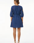 Back view of the Fanm Mon Pearl Dress featuring three-quarter balloon sleeves, a self-tie waist, floral embroidery, and contrast embroidered trim.