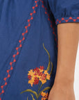 Close-up of the Fanm Mon Pearl Dress highlighting the floral embroidery, contrast embroidered trim, and three-quarter sleeve detailing.