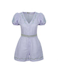 Light purple romper with decorative buttons and waistband on a white background. Fanm Mon Rabia Romper.