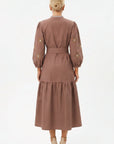 Back view of the Fanm Mon Samara Dress featuring floral embroidered sleeves, a belted waist, and gathered A-line midi skirt.