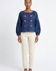 Model wearing Fanm Mon Akik Top with fire floral embroidery and voluminous long sleeves