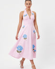 Model wearing the Fanm Mon Ayna Dress with blue floral embroidery, a plunging halter neckline and full A-line midi skirt.