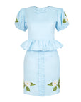 Fanm Mon Ether Set in light lagoon featuring a puff-sleeve peplum top with bow neckline, coordinating ruffle-front mini skirt, and white floral embroidery