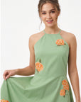 Detail of the Fanm Mon Fora Dress featuring orange hydrangea embroidery and a delicate halterneck silhouette.