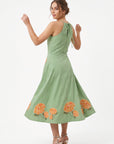 Back view of the Fanm Mon Fora Dress with a self-tie halterneck and hydrangea embroidery along the full midi skirt.