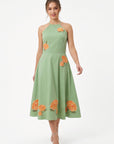 Model wearing the Fanm Mon Fora Dress with a halterneck bodice, hydrangea embroidery and a full A-line midi skirt.