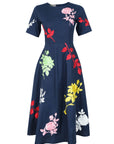 Fanm Mon Gandi Dress in navy featuring a round neckline, short sleeves, fitted bodice, and colorful floral embroidery across an A-line midi skirt