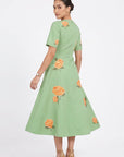 Back view of model wearing the Fanm Mon Gemlik Dress with scattered hydrangea embroidery and a full A-line midi silhouette.