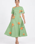 Model wearing the Fanm Mon Gemlik Dress with hydrangea embroidery, short sleeves and a full A-line midi skirt.
