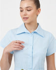 Close-up of Fanm Mon Jahan Dress in light blue showing the tailored collar, fabric-covered buttons, and delicate white floral embroidery on the waist belt