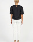 Back view of model wearing Fanm Mon Kehribar Top in black with short sleeves and keyhole neckline