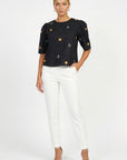 Model wearing Fanm Mon Kehribar Top in black with scattered floral embroidery and short puff sleeves