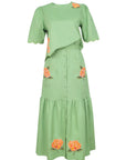 Fanm Mon Komarna Set in green featuring a short-sleeve scalloped top with botanical embroidery and a coordinating button-front midi skirt with embroidered patch pockets and a gathered hem