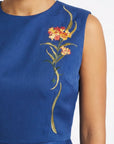 Close-up of floral embroidery on Fanm Mon Marena peplum top in deep blue