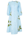 Fanm Mon Paysan Dress in light blue with white embroidered flowers, green foliage, fabric-covered buttons, and puff sleeves