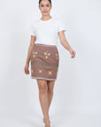 Fanm Mon Roya Skirt on model featuring daisy embroidery, decorative embroidered bands and a high-waisted mini silhouette
