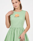Detail of the Fanm Mon Seher Dress featuring orange floral embroidery at the bodice and a round neckline.