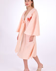 Fanm Mon Dayna Linen Dress Side View. Showcasing Kimono Sleeve, Embroidery detail, Plunging Neckline with Tie Front, and length.