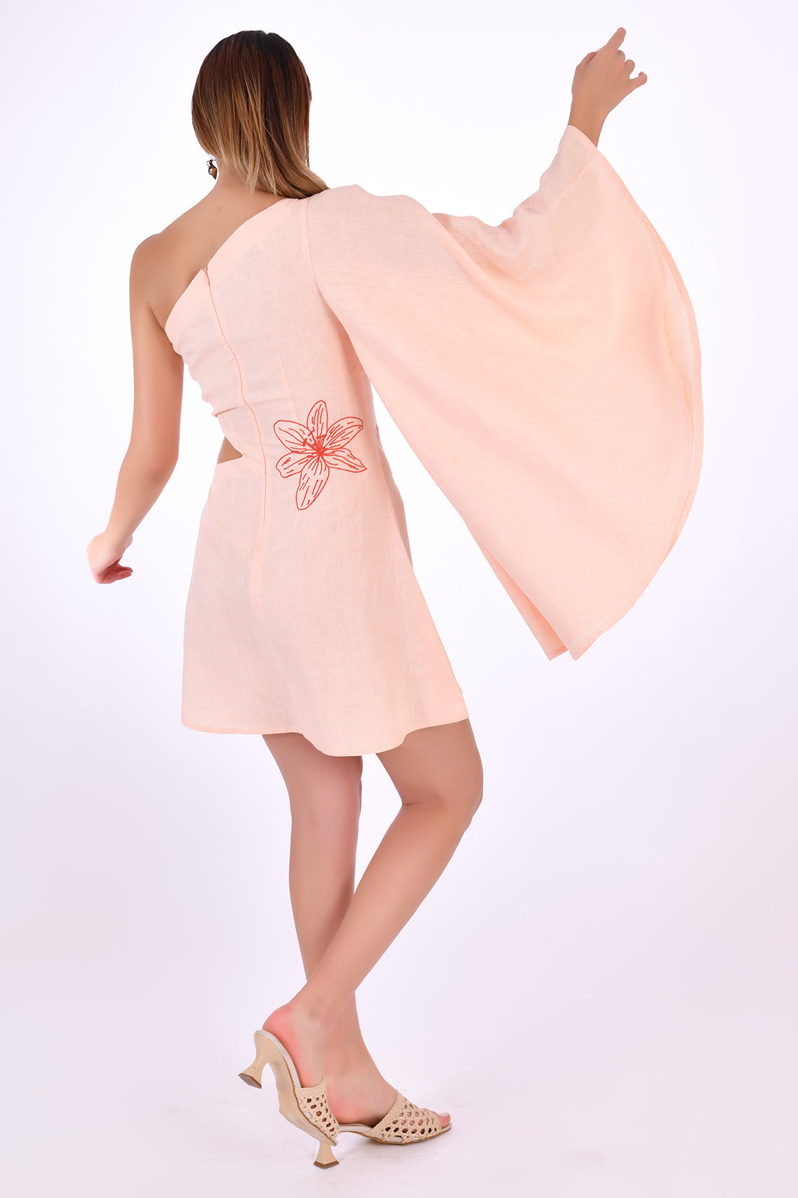 Fanm Mon Kame Linen Dress, showcasing back view with back embroidery detail and one shoulder bell sleeve.