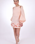 Fanm Mon Gizem Mini Linen Dress, Made to Measure with puff sleeve and featuring embroidery detail. Walking View.