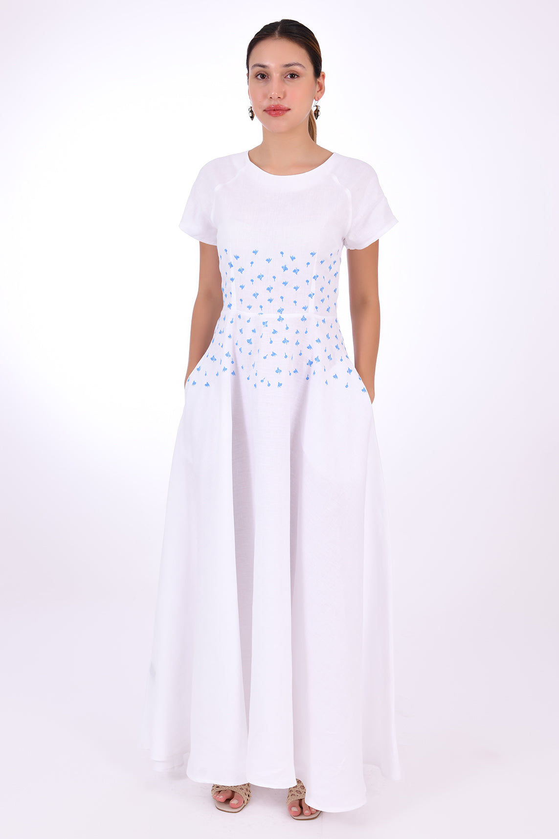 Fanm Mon Firsdevs Linen Dress, Front View. Timeless Tea-length Luxurious Linen Dress. 100% linen, Made to Measure. This classic dress is the perfect expression of modern elegance in an A-line silhouette that features cap sleeves and round neck, embellished with both front and back waist embroidery, and subtle side pockets.
