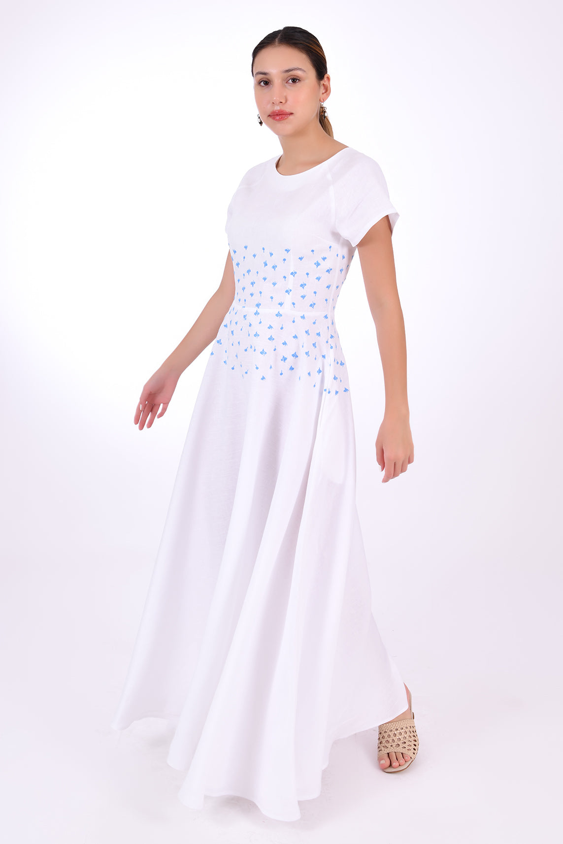 Fanm Mon Firsdevs Linen Dress, Side View. Timeless Tea-length Luxurious Linen Dress. 100% linen, Made to Measure. This classic dress is the perfect expression of modern elegance in an A-line silhouette that features cap sleeves and round neck, embellished with both front and back waist embroidery, and subtle side pockets.
